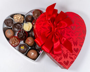 8 ounce red Heart-shaped box of chocolates with a red ribbon