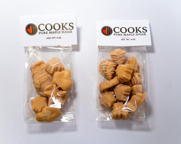 Two packages of Cooks Pure Maple Sugar on a white background